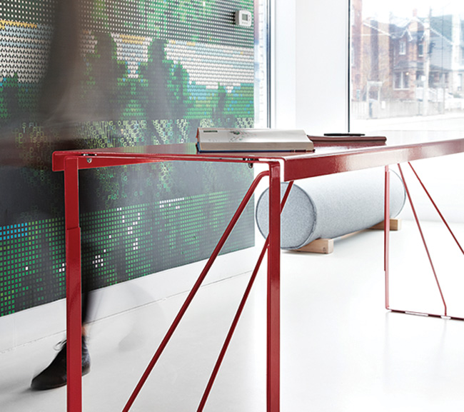 Common Good (Commercial Studio):
Upholstered “log” seats (made by DesignRepublic) and a red, bar-height “kitchen table” (made by Kenadian) furnish the pristine space.