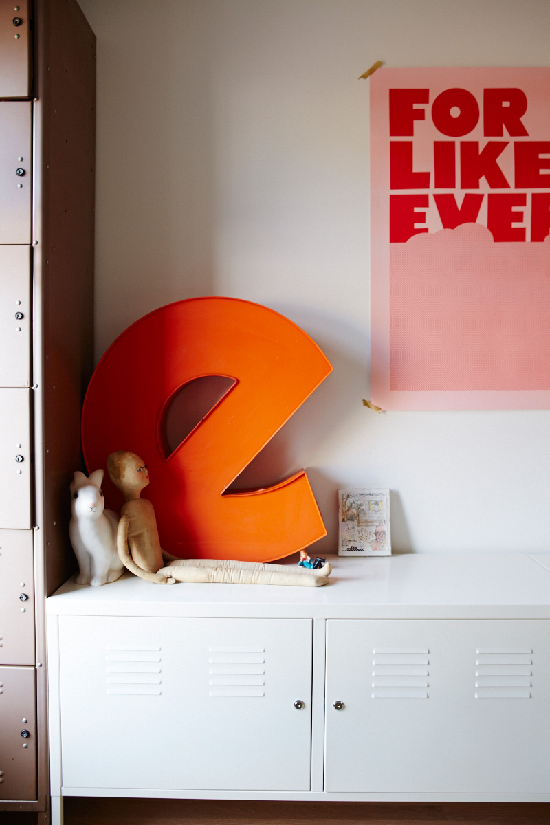 In the nursery, clothes and toys are tucked into lockers from Queen West Antiques. The E sign is a Junction Flea find; print by Tracy Jenkins for Village.