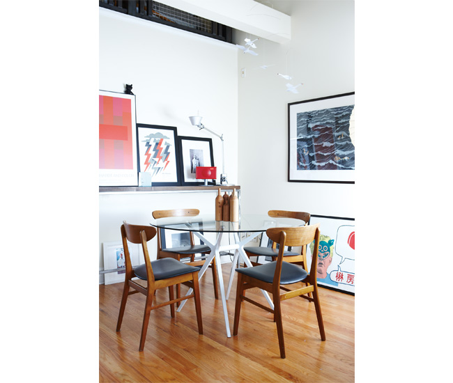 A DesignRepublic table and antique chairs are circled by even more local art, including a Doublenaut print (middle
of shelf).