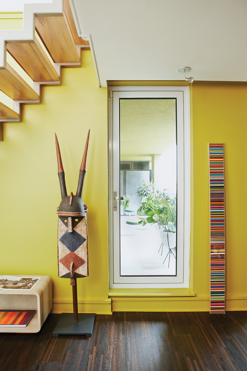 The patio doorway is framed with a ceremonial mask from Burkina Faso and Douglas Coupland’s pencil crayon sculpture. Photo by Naomi Finlay.