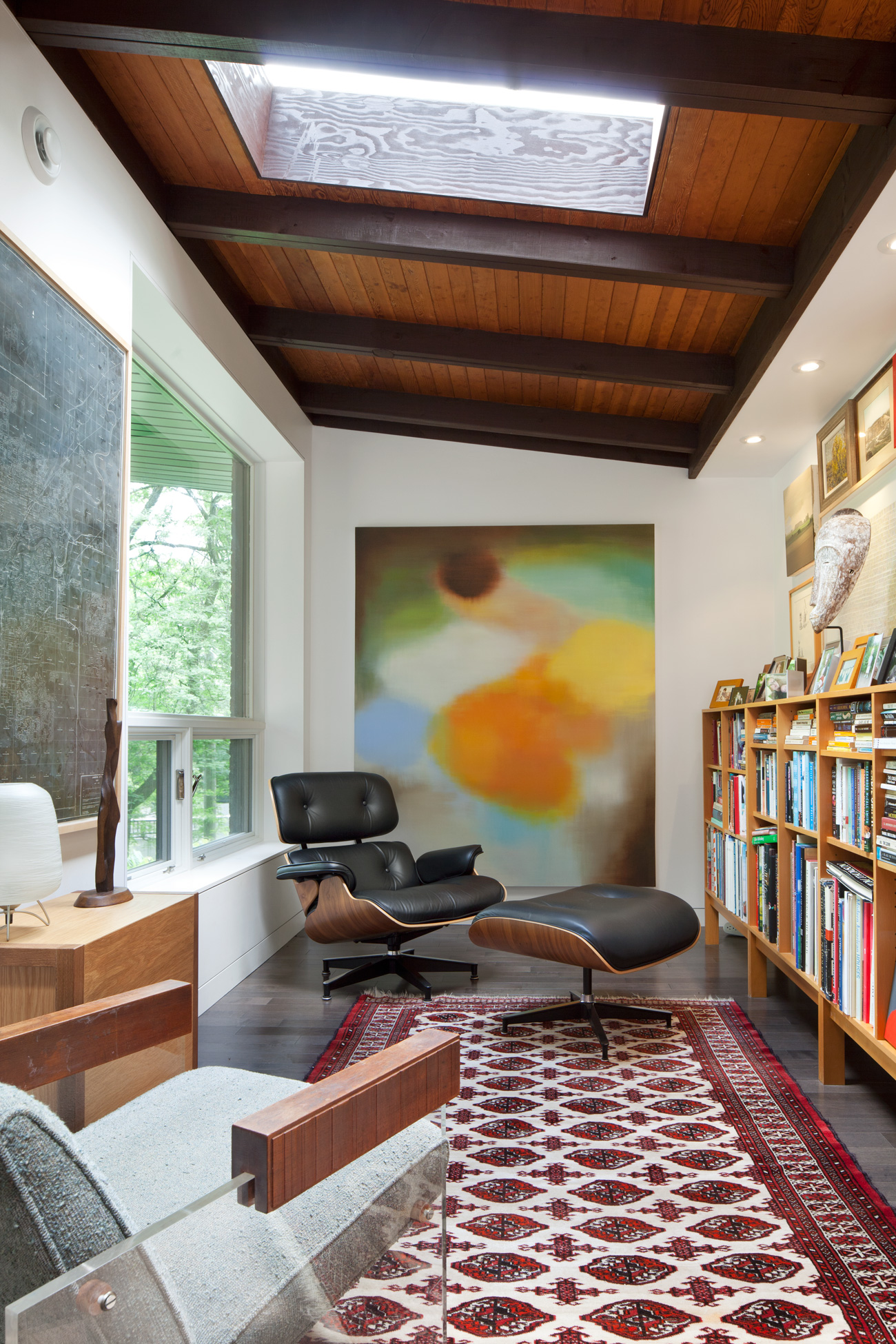 Study filled with mod furniture, art and books. The room is lit by one of two new skylights.
