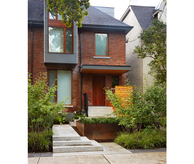 Cascading steps in polished concrete and neatly contained shrubs in a raised garden bed complement a Georgian’s structural reinvention in Rosedale. 