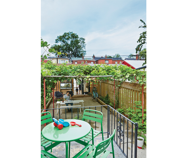 A 74-square-metre patio – covered with grapevines and lined with herb and flower beds – separates home and studio.