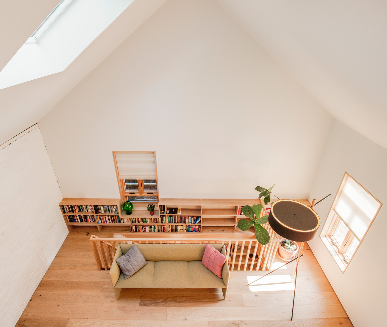 Two bedrooms and a bathroom upstairs are housed in an oak-clad structure. Above will be a lounge accessible by ladder. Sofa from Mjölk; lamp from LightForm.