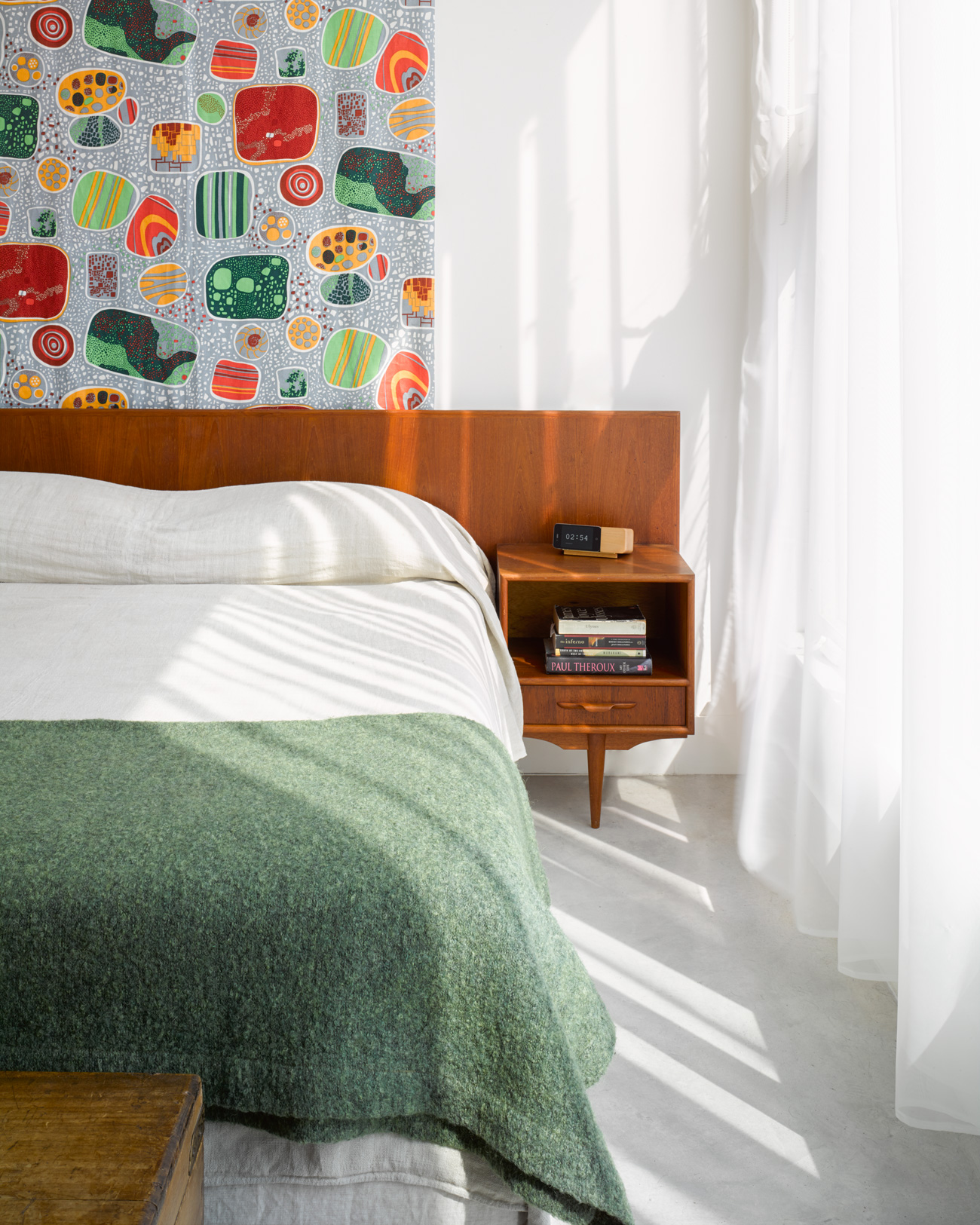 Josef Frank’s linen Terrazzo hangs behind the vintage teak bed with floating nightstands (a G.U.F.F. find). 