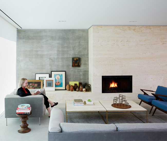 A honed travertine-encased Heatilator fireplace warms up the cool, board-formed concrete walls. Photo by Naomi Finlay.
