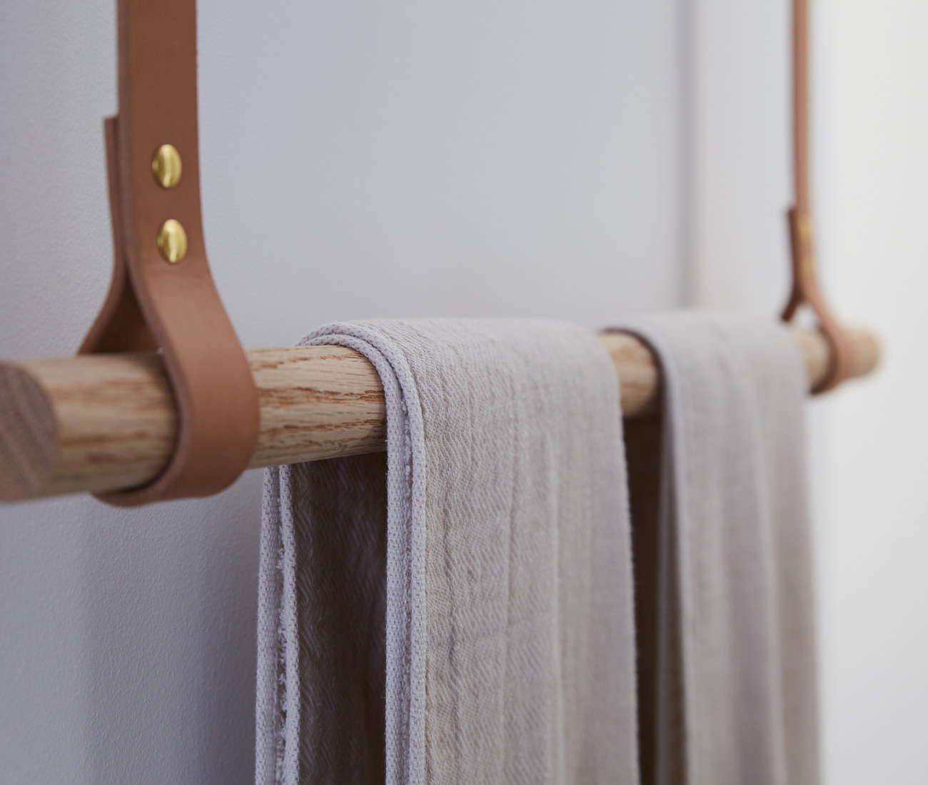 Another ingenious custom flourish: an oak dowel towel rack, hung on ceiling-mounted, tanned leather straps. Photo by Naomi Finlay.