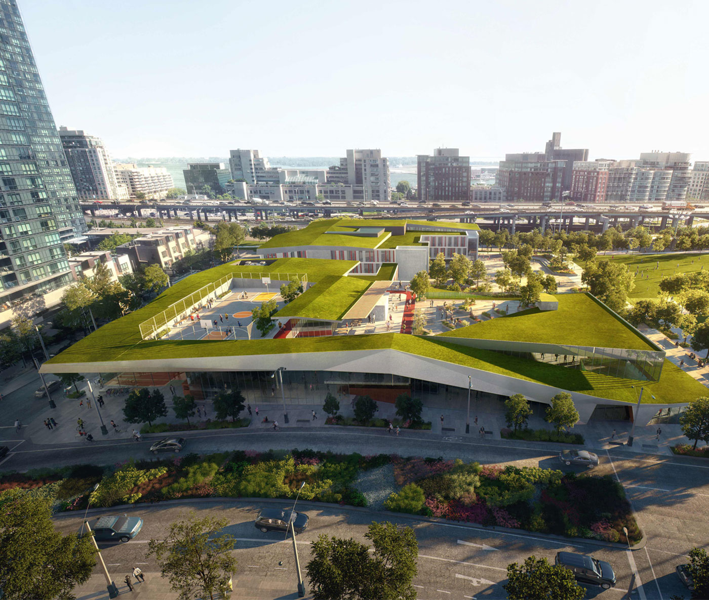 Topped with a green roof that houses a basketball court and running track, the sloped facilities echo the hilly terrain of the adjacent Canoe Landing Park.