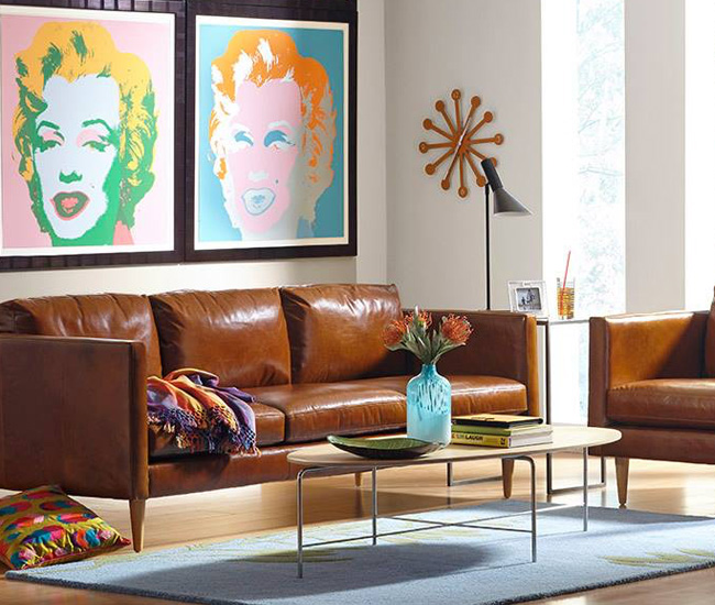 Couch and coffee table with art on the wall from Chesterfield Shop