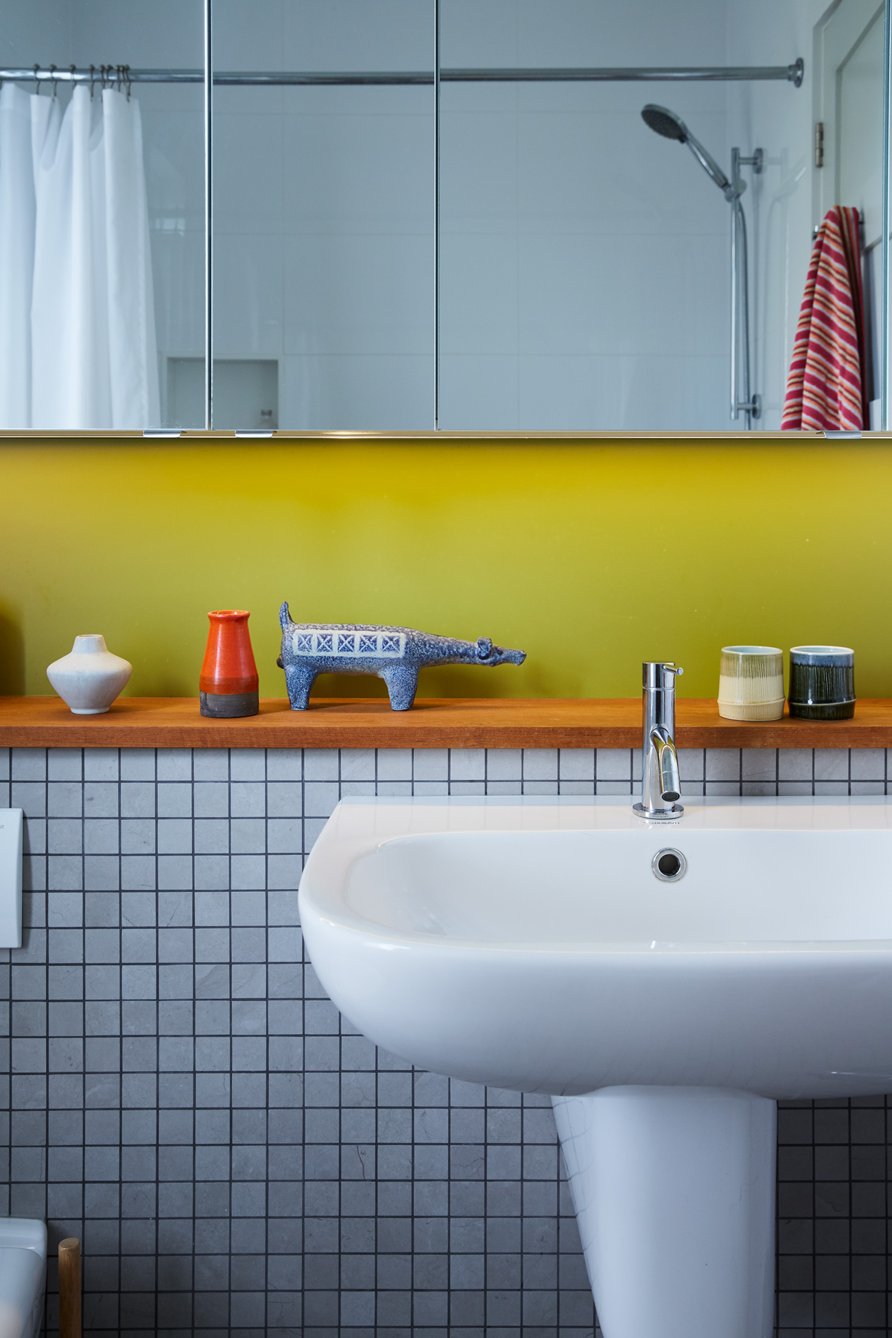 Mosaic tile from Ciot and chartreuse paint jazz up the bathroom. Cabano faucet from Taps.