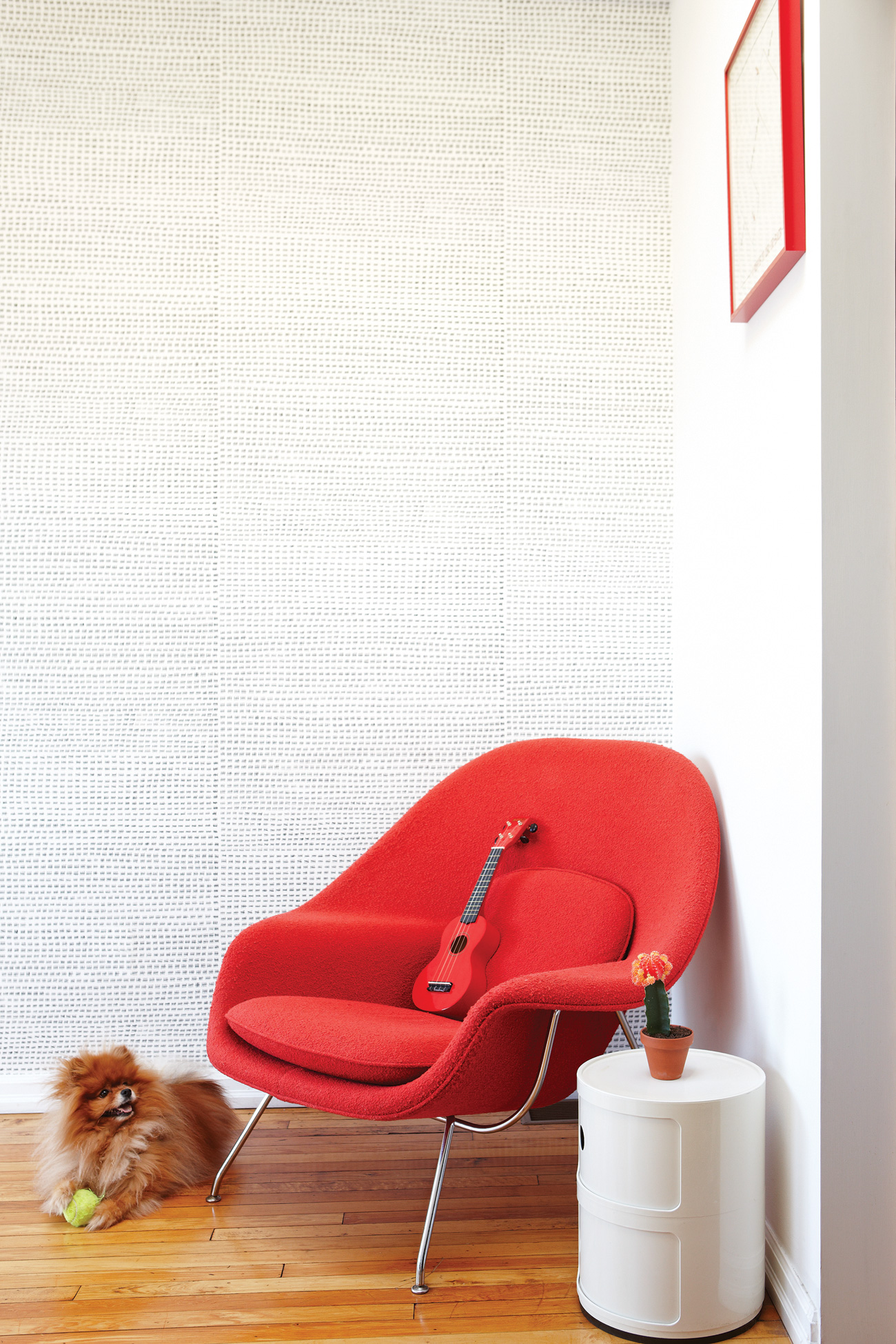 Kelly Mark’s 12345 wallpaper, with its tight rows of tally marks, was the perfect choice for the upstairs office. Womb chair available at Design Within Reach; the Kartell side table can be found at Quasi Modo.