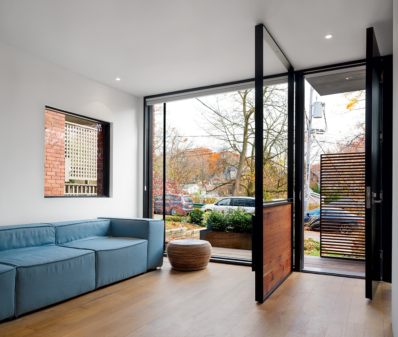 The entryway’s steel frame features a thin tray for stashing keys, and supports a flat screen TV opposite the sofa.