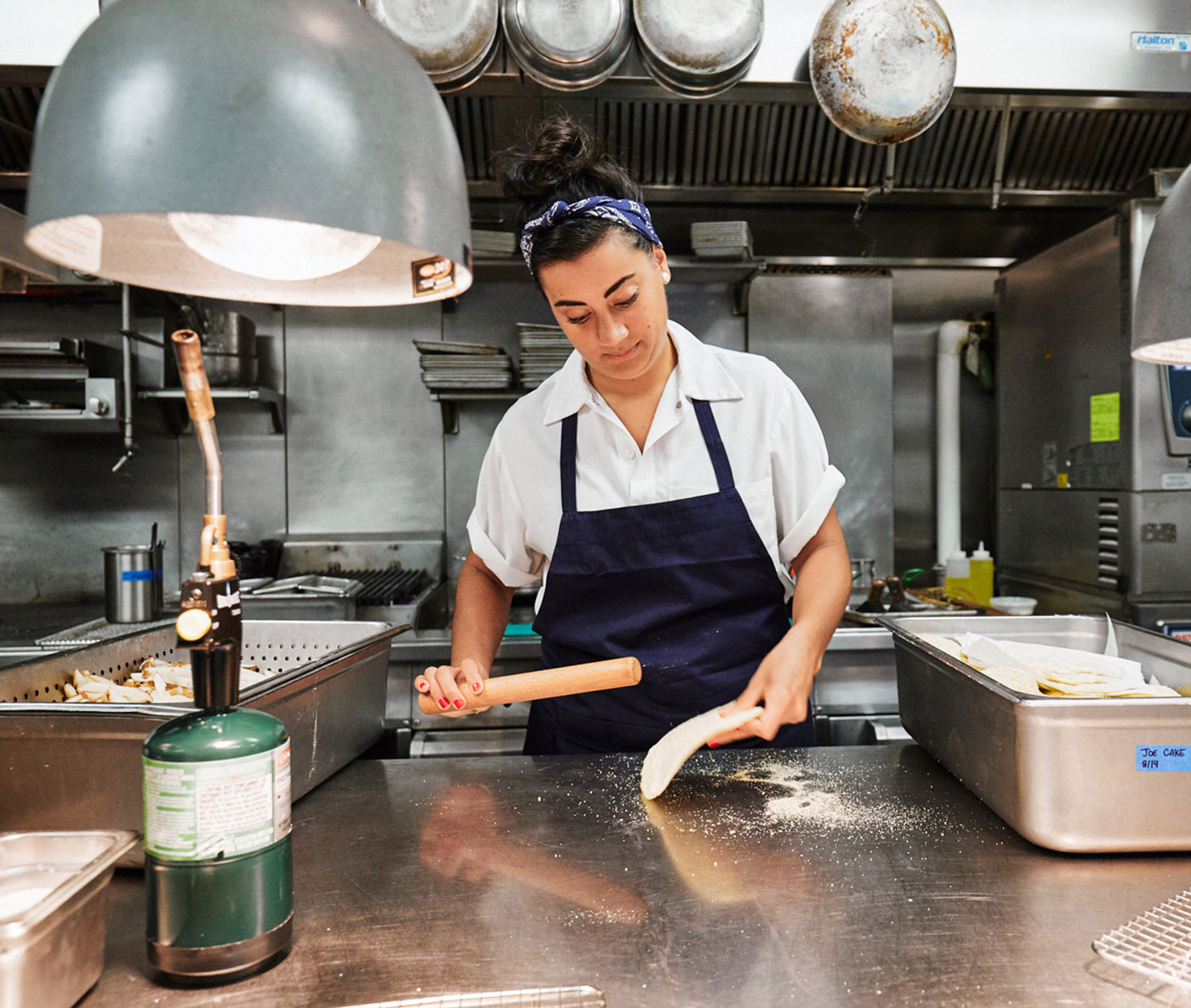 Chef Paula Navarrete preparing food at Kōjin restaurant in Toronto