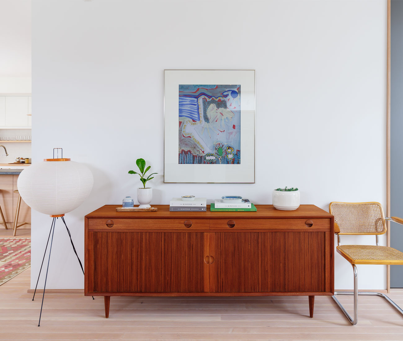 A Noguchi lamp illuminates the vintage furniture finds found throughout the house. 