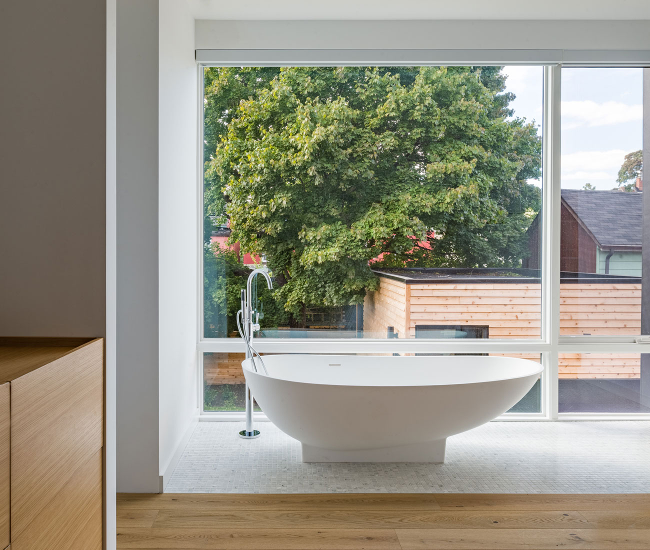 The master suite includes this bathtub, overlooking the lush yard. 