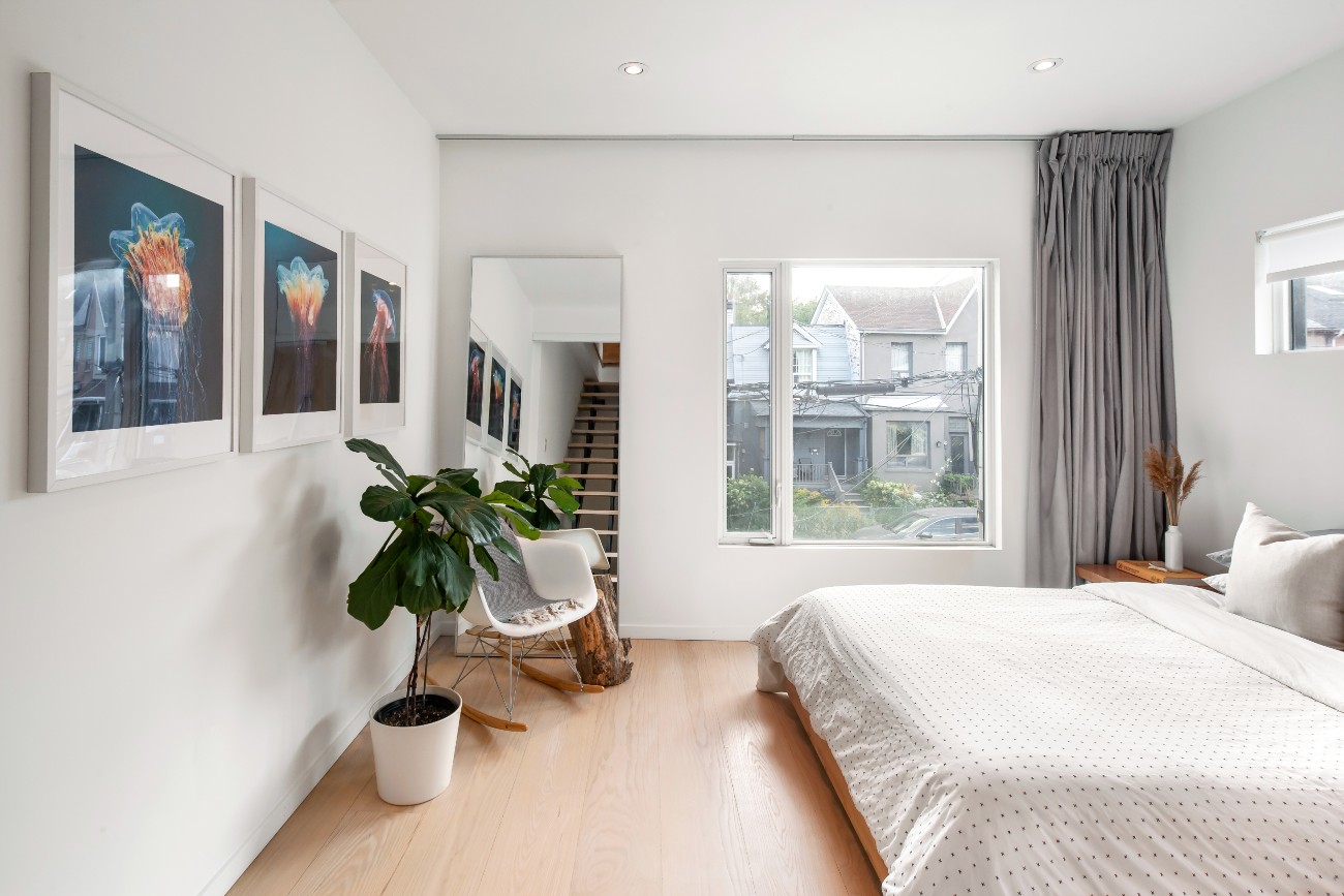 The guest bedroom gets plenty of light – and, if desired, fresh air – via a European-style turn-and-tilt fibreglass window, which are used throughout the home. Like the backyard, jellyfish art also features.