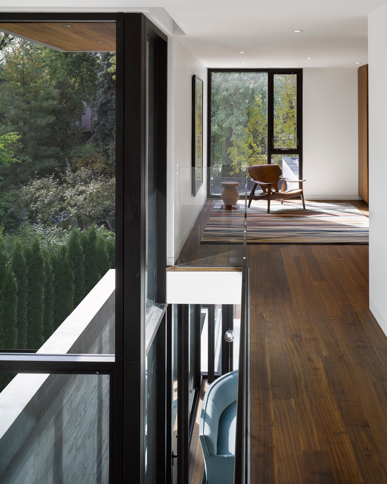 Light-filled three-storey light well illuminating the basement, first floor, and mezzanine - Drew Mandel design toronto