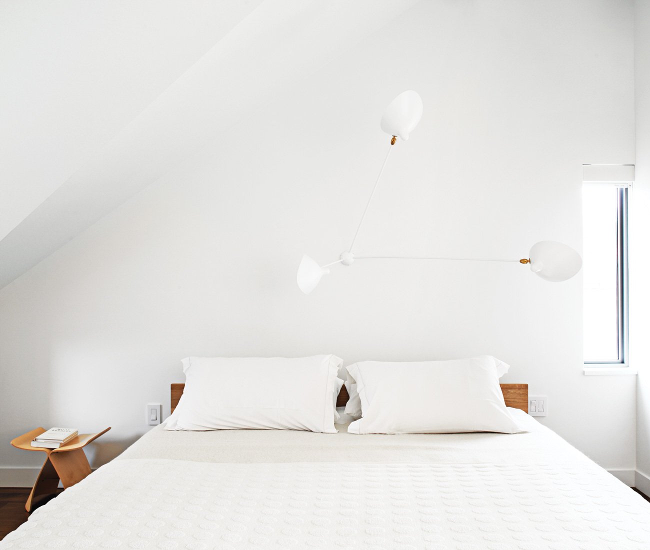 A three-armed sconce by Serge Mouille