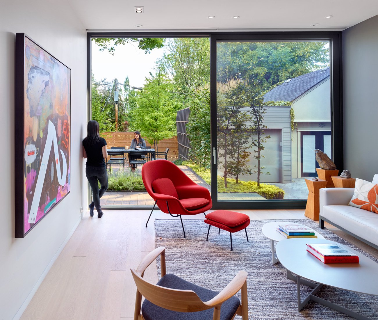 Sliding glass wall from Bigfoot Doors opens up the living room in the backyard