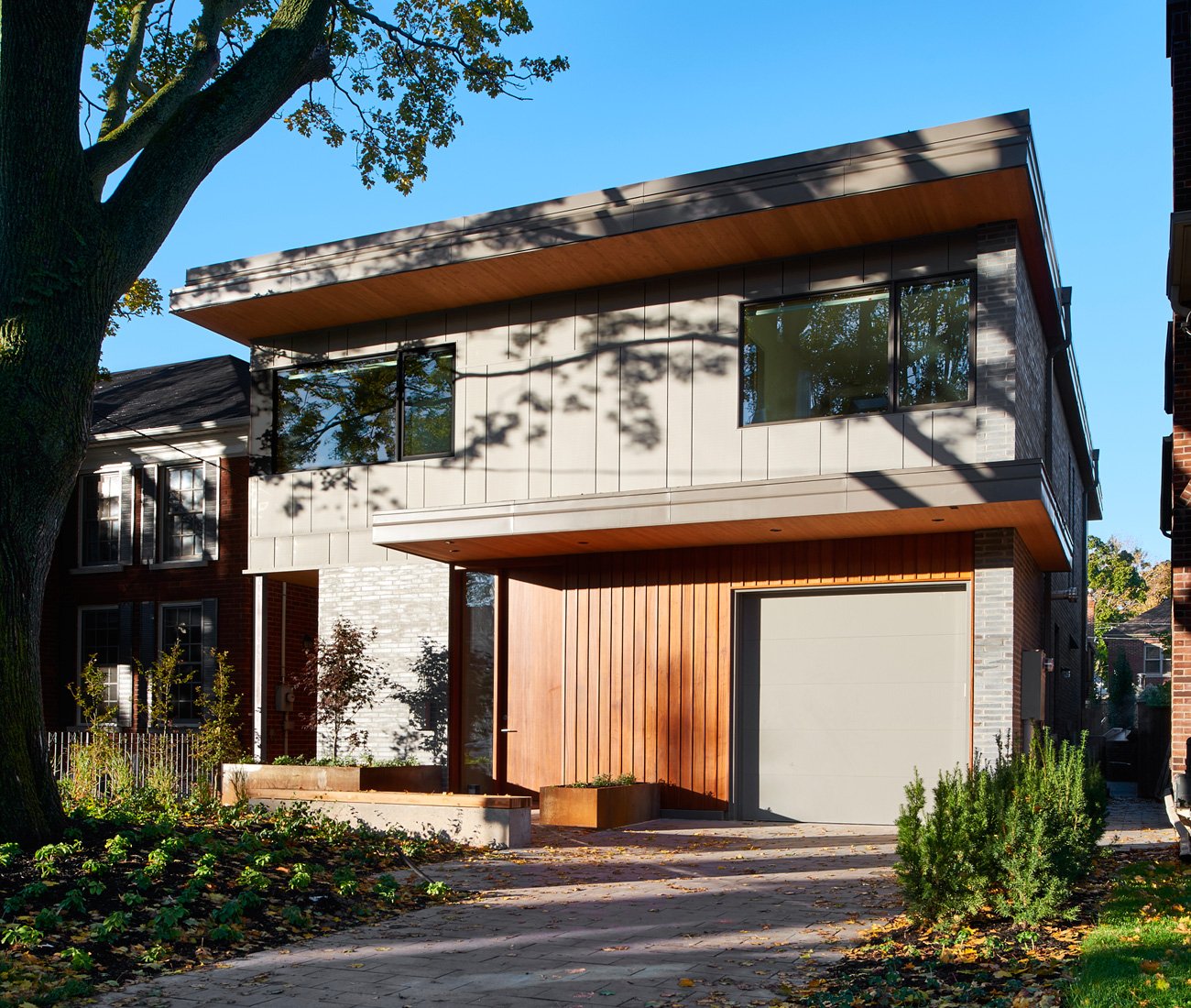 Mahogany and zinc panelling accents the black brick-clad Leaside home