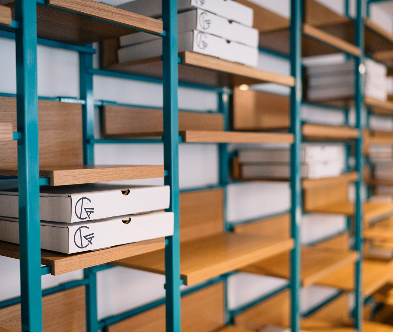 Shelves displaying pizza boxes