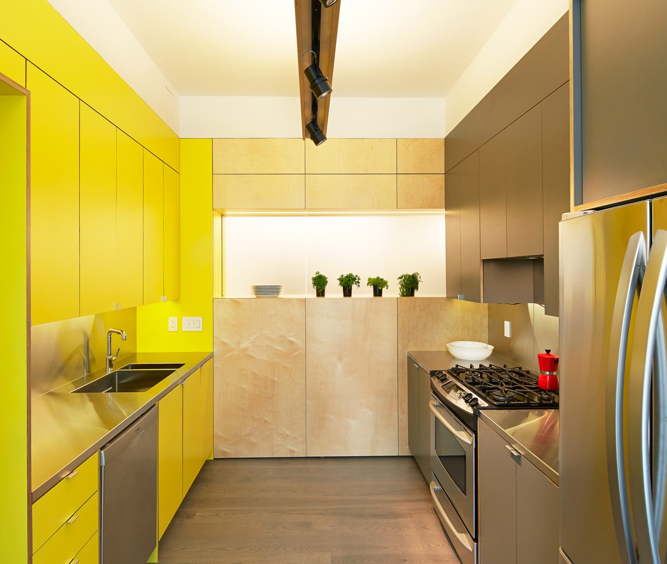 Yellow cabinetry in a condo kitchen interiors in Toronto