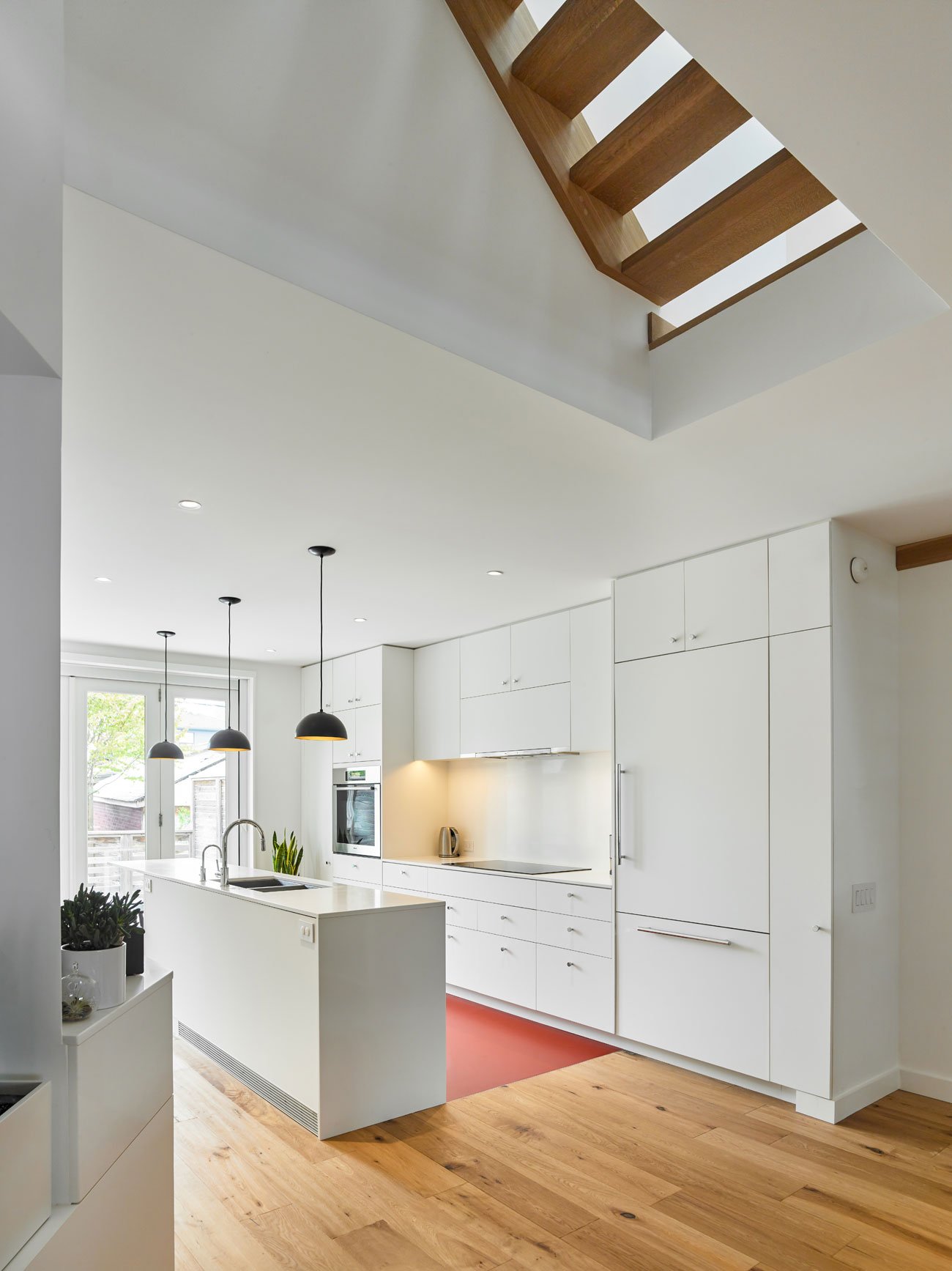 Works Office of Brian O'Brian Architect Toronto Architecture Designlines Home White kitchen with an island on a Leslieville semi by Brian O’Brian Architect