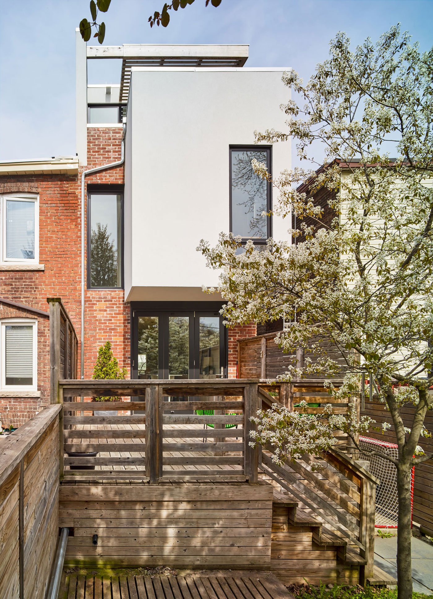 Works Office of Brian O'Brian Architect Toronto Architecture Designlines Home View of a Leslieville semi backyard with second-storey addition cantilevers and cedar pergola–covered green roof. Brian O’Brian Architect