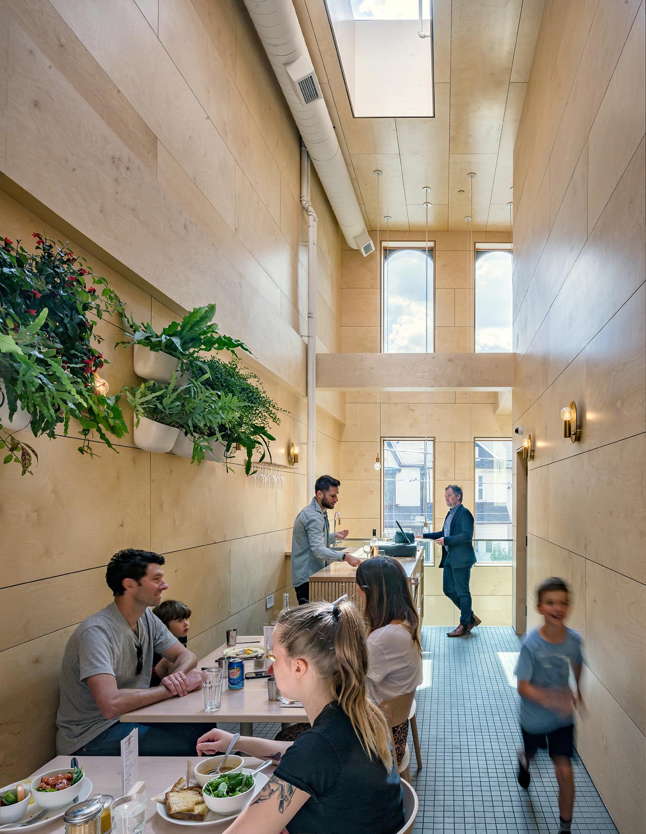 Interior of Lady Marmalade with seating area and people dining - Omar Gandhi architect