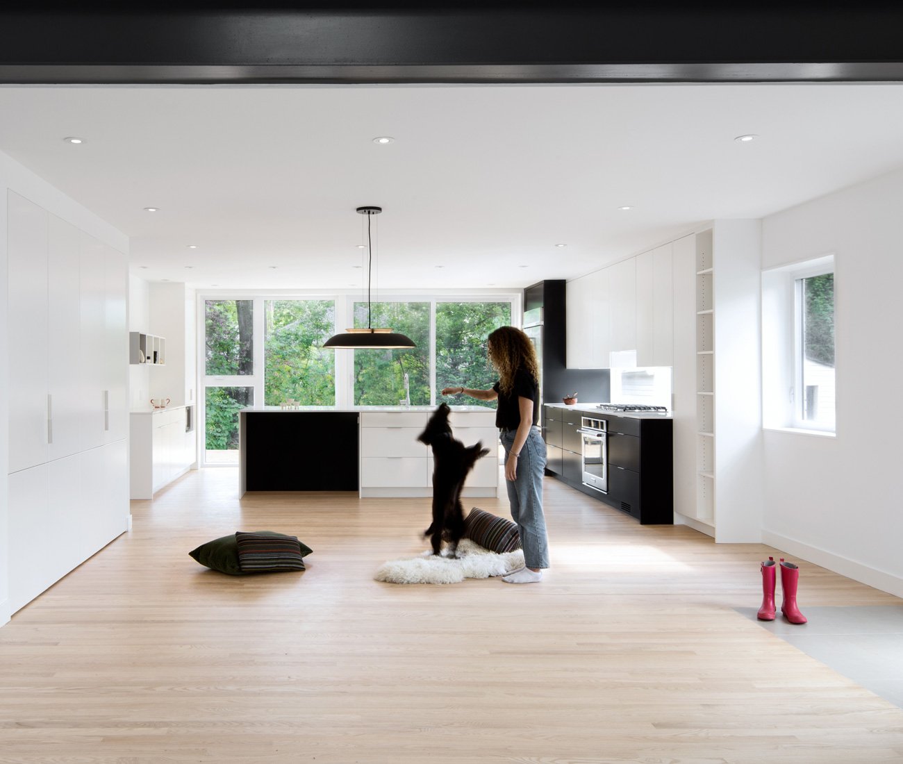 a young woman playing with her dog in a Post Architecture Bungalow renovation.
