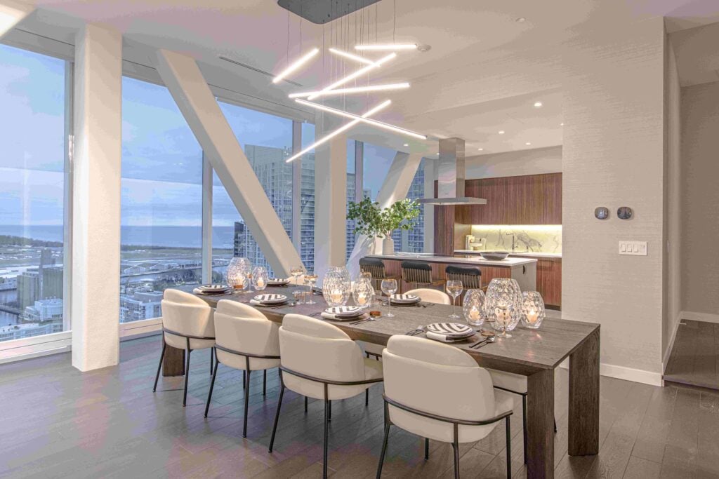 Skybridge Toronto condo interiors, dining room table with light pendants