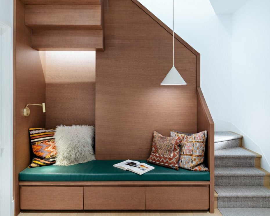 Sculptural dark oak staircase connecting the main floor to the upper levels in a renovated Georgian home.