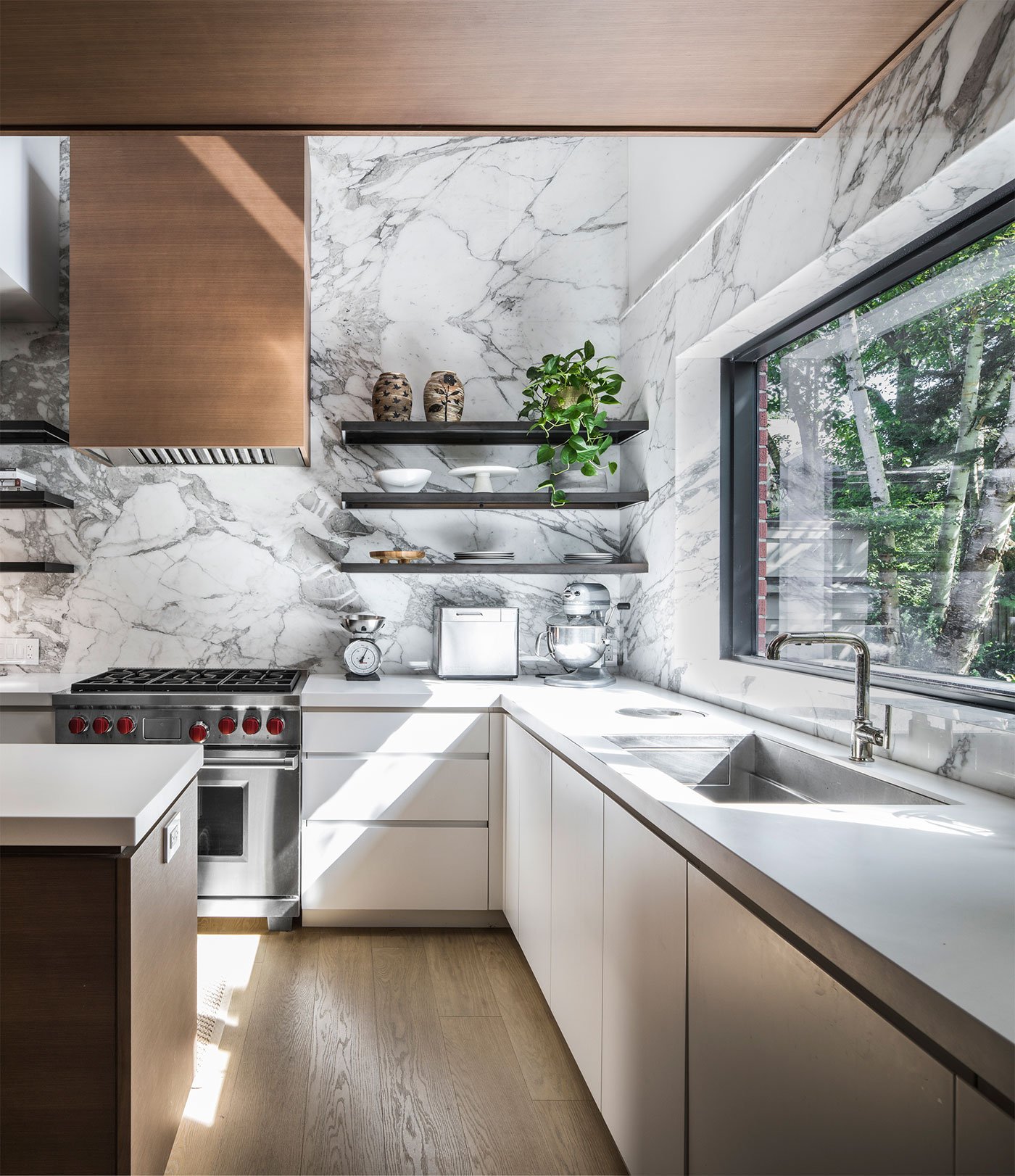 Kitchen layout design with marble backsplash by Wayback Architects