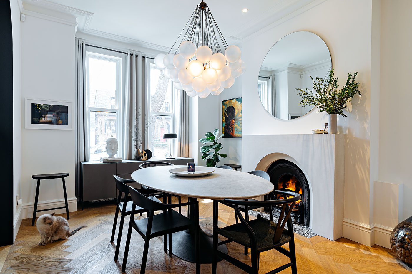 Dining room with table chandelier and fire place - Boswell House by Wayback Architects