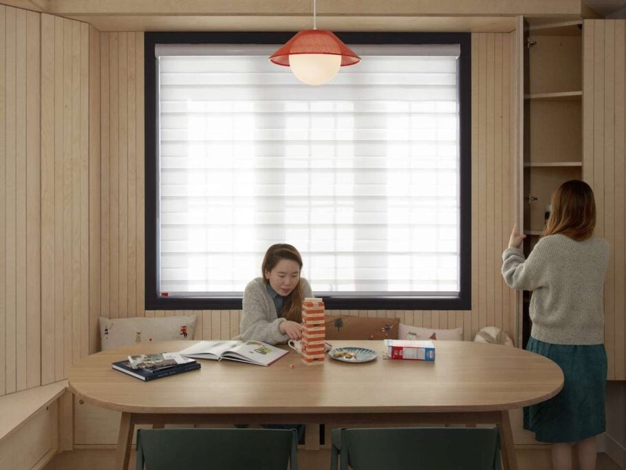 Vertically cut plywood slats create a cozy, log cabin-inspired playroom