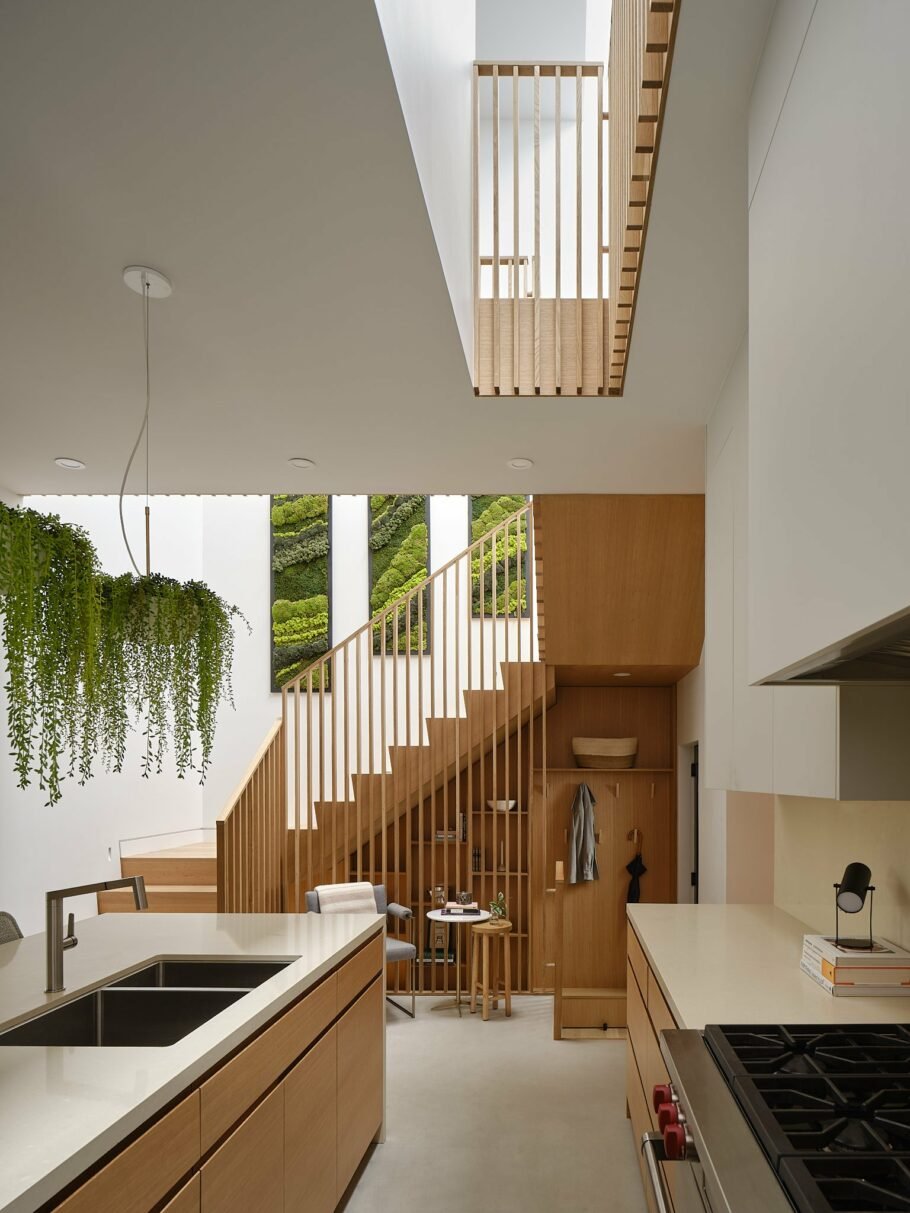 Wood slat wall in a primary staircase serving as a room divider, shelving enclosure, and stair railing - Vanessa Fong Architect