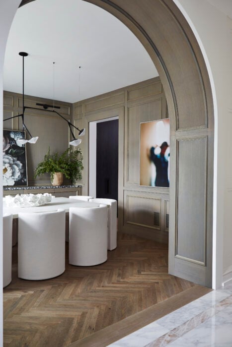 Arches distinguish a pathway between the kitchen and dining room.