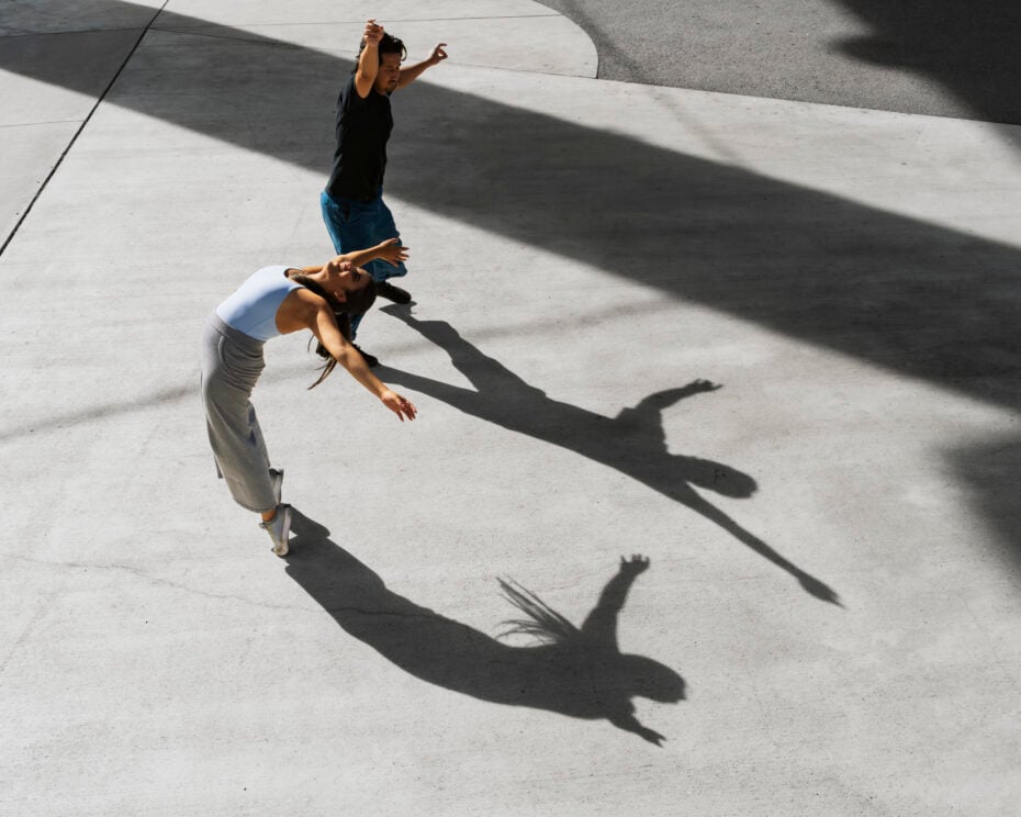 People making shadows on pavement