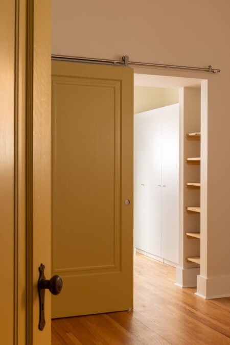 upstairs hallway with yellow sliding door